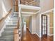 Spacious foyer featuring hardwood floors, staircase with iron railings, and an open view to the upper level at 612 Longer Dr, Peachtree City, GA 30269