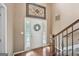 Elegant foyer with hardwood floors, a decorative wreath on the front door, and a staircase to the upper level at 612 Longer Dr, Peachtree City, GA 30269