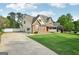 Inviting two-story home with a spacious driveway, brick accents, a covered porch, and a well-maintained lawn at 612 Longer Dr, Peachtree City, GA 30269