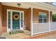 Inviting front entry featuring a decorative wreath on the door, a cozy mat, and a charming covered porch at 612 Longer Dr, Peachtree City, GA 30269