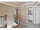 Upstairs hallway features wrought iron balusters and views of the hall bath at 612 Longer Dr, Peachtree City, GA 30269