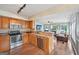 Spacious kitchen with stainless steel appliances, wooden cabinets, and a view into the living room at 612 Longer Dr, Peachtree City, GA 30269