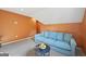 Cozy angled living room with orange walls, modern furnishings, and carpeted floors at 612 Longer Dr, Peachtree City, GA 30269