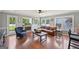 Cozy living room featuring hardwood floors, a stone fireplace, and abundant natural light from numerous windows at 612 Longer Dr, Peachtree City, GA 30269