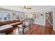 Bright living room with hardwood floors, modern ceiling fan, and bar seating adjacent to the kitchen at 612 Longer Dr, Peachtree City, GA 30269