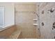 Close up of the elegant shower with dual shower heads, a granite bench, and tile surround at 612 Longer Dr, Peachtree City, GA 30269