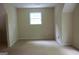 Basement area with a window allowing natural light and neutral walls, providing ample space at 695 Frog Rd, Locust Grove, GA 30248