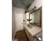 Unique bathroom featuring a sink with industrial faucet, granite countertop, and wood look flooring at 695 Frog Rd, Locust Grove, GA 30248
