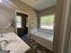 Bright bathroom showcasing a soaking tub, separate shower, and dual sinks with natural lighting at 695 Frog Rd, Locust Grove, GA 30248