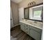 Bathroom with a double sink vanity, decorative mirror and hardware and wood look flooring at 695 Frog Rd, Locust Grove, GA 30248