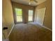 Cozy bedroom featuring plush carpeting, neutral walls, ceiling fan, and abundant natural light from the windows at 695 Frog Rd, Locust Grove, GA 30248