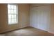 Cozy bedroom with carpeted floors, bright window and a spacious closet, providing a relaxing retreat at 695 Frog Rd, Locust Grove, GA 30248