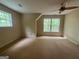 Spacious bedroom featuring neutral carpeting, natural lighting, and a ceiling fan at 695 Frog Rd, Locust Grove, GA 30248
