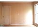 Carpeted room featuring a window with natural light, and neutral walls creating a serene atmosphere at 695 Frog Rd, Locust Grove, GA 30248