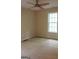Neutral-toned bedroom featuring a ceiling fan and ample natural light from the large window at 695 Frog Rd, Locust Grove, GA 30248