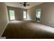 Spacious bedroom featuring plush carpeting, neutral walls, and abundant natural light from the large windows at 695 Frog Rd, Locust Grove, GA 30248
