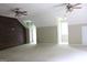 Spacious carpeted bonus room features a unique tree mural, wood accent wall and dual ceiling fans at 695 Frog Rd, Locust Grove, GA 30248