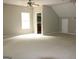 Open concept bonus room with neutral carpet and view of an adjacent full bathroom at 695 Frog Rd, Locust Grove, GA 30248