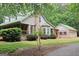 Lovely home with a green metal roof, brick accents, and lush landscaping providing great curb appeal at 695 Frog Rd, Locust Grove, GA 30248