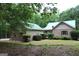 Charming home exterior with well-maintained landscaping, brick facade, and inviting curb appeal at 695 Frog Rd, Locust Grove, GA 30248