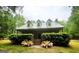 Charming brick home featuring a metal roof, dormers, covered porch, and manicured landscaping at 695 Frog Rd, Locust Grove, GA 30248