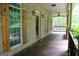 Inviting brick front porch with wood railings, shutters, and exterior lighting at 695 Frog Rd, Locust Grove, GA 30248