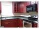 Well-lit kitchen featuring stainless steel appliances and dark wood cabinetry, offering a functional cooking space at 695 Frog Rd, Locust Grove, GA 30248