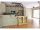 Open kitchen and dining area with hardwood floors, breakfast bar and decorative lighting at 695 Frog Rd, Locust Grove, GA 30248