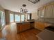 Bright kitchen featuring hardwood floors, breakfast bar and stainless steel dishwasher at 695 Frog Rd, Locust Grove, GA 30248