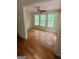 Inviting living area with wood floors and three windows offering scenic views of the outdoors at 695 Frog Rd, Locust Grove, GA 30248