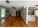 Open-concept living area featuring hardwood floors, natural light, and a rustic sliding barn door at 695 Frog Rd, Locust Grove, GA 30248