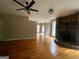 Spacious living room featuring a stone fireplace, hardwood floors, and lots of natural light at 695 Frog Rd, Locust Grove, GA 30248