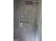 Modern shower showcasing gray tiling, sleek fixtures, and a convenient built-in niche at 695 Frog Rd, Locust Grove, GA 30248