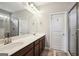 Bright bathroom with double sink vanity, dark wood cabinets and a separate shower at 120 Westover Commons, Fayetteville, GA 30214