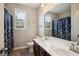 Functional bathroom featuring a double sink vanity, modern fixtures, and a shower with patterned curtain at 120 Westover Commons, Fayetteville, GA 30214
