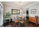 Elegant dining area with a glass-top table, stylish chairs, and a decorative chandelier at 120 Westover Commons, Fayetteville, GA 30214