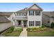 Charming two-story home boasts a covered front porch, manicured landscaping, and classic architectural details at 120 Westover Commons, Fayetteville, GA 30214