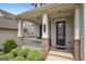 Inviting front porch with stone accents, elegant columns, seating, and a stylish front door, perfect for relaxing at 120 Westover Commons, Fayetteville, GA 30214