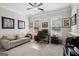 Bright home office features neutral colors, large window, and desk area with comfortable seating at 120 Westover Commons, Fayetteville, GA 30214