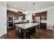 Gourmet kitchen featuring a large island with seating, stainless steel appliances, and dark wood cabinetry at 120 Westover Commons, Fayetteville, GA 30214