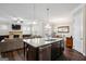 Modern kitchen boasts granite counters, stainless steel appliances, and opens to the living and dining areas at 120 Westover Commons, Fayetteville, GA 30214