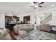 Open-concept layout seamlessly connects the living room and kitchen with a large sofa and hardwood floors at 120 Westover Commons, Fayetteville, GA 30214