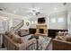 Spacious living room with a stone fireplace, plush seating, and ample natural light, creating a comfortable space at 120 Westover Commons, Fayetteville, GA 30214