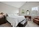 Relaxing main bedroom with neutral tones, a decorative mirror, and natural light at 120 Westover Commons, Fayetteville, GA 30214