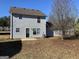 Backyard with a green door, neutral siding, and a young tree at 253 Whistle Way, Locust Grove, GA 30248