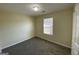 Bedroom featuring neutral walls, carpet, and a window at 253 Whistle Way, Locust Grove, GA 30248