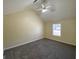 A spacious bedroom with neutral walls, carpet, a ceiling fan, and natural light from a large window at 253 Whistle Way, Locust Grove, GA 30248