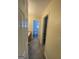 Hallway view featuring carpeted floors and doorways leading to a bathroom and closet at 253 Whistle Way, Locust Grove, GA 30248