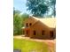Two-story home under construction shows exposed wood frame with some windows, surrounded by lush trees and greenery at 107 Oak Rd, Locust Grove, GA 30248