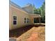 Back exterior view of new house featuring a covered patio and many windows, perfect for natural light at 107 Oak Rd, Locust Grove, GA 30248